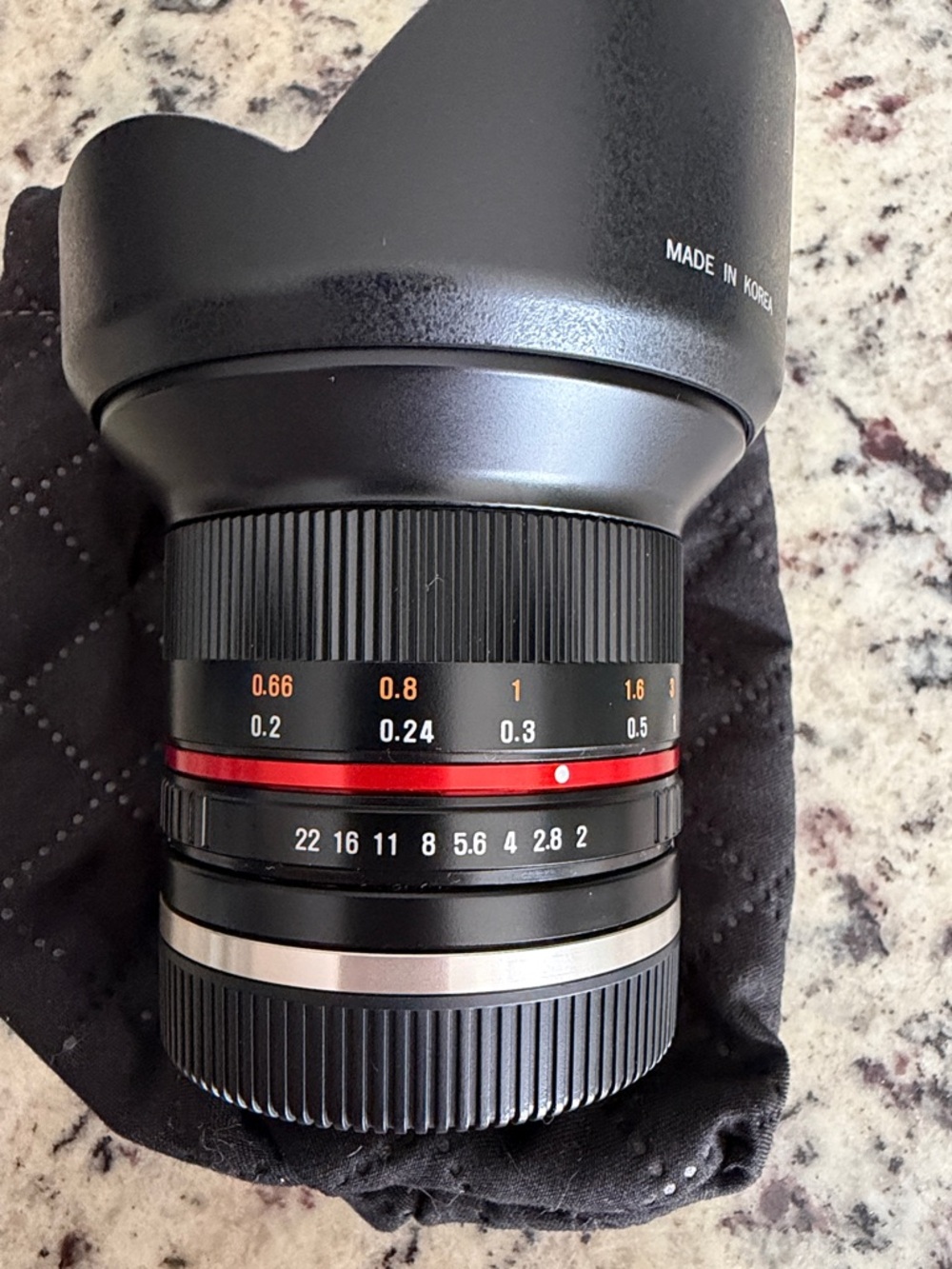 Rokinon 12mm F2 manual focus lens, with hood, and Drawstring Pouch. Sony E mount